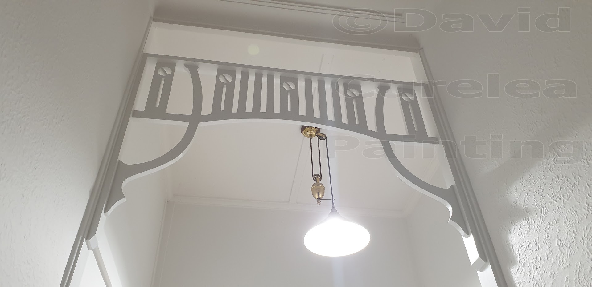 Timber fretwork in a painted hallway archway