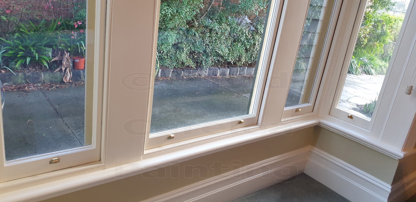 A bay window with painted timber frames and sill
