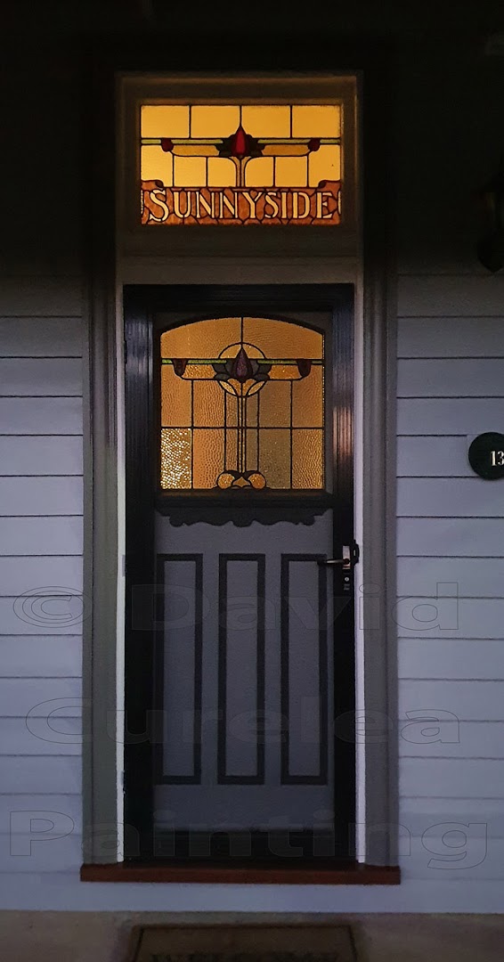 A heritage front door below a Sunnyside leadlight fanlight, painted by David Curelea