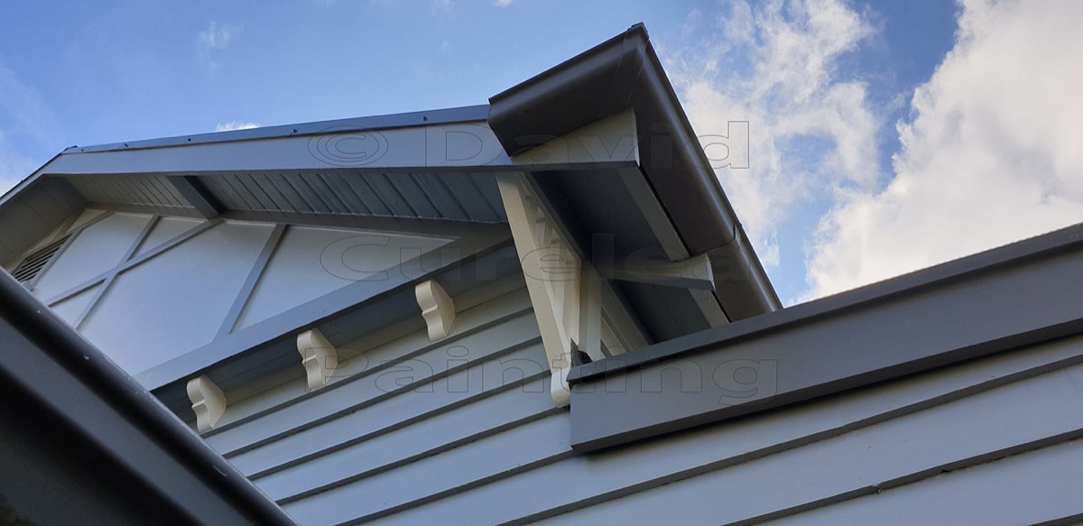 A painted gable and eaves against the sky