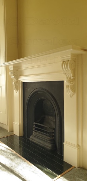 A period fireplace surround finished in cream