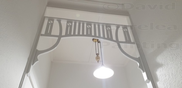 Timber fretwork in a painted hallway archway