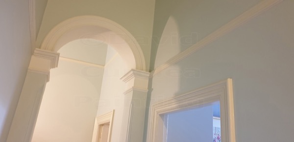 An arched interior opening with painted plasterwork