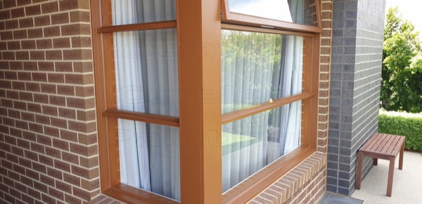 A painted timber window frame set into brickwork