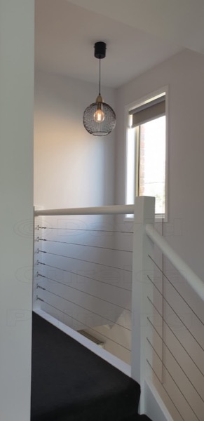 A stairwell with painted walls and balustrade