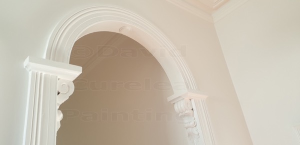 A painted plaster arch with corbel detail