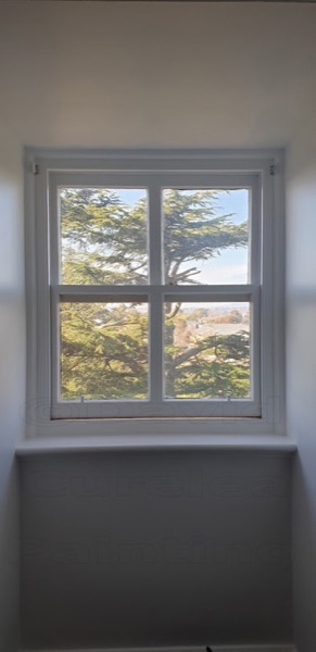 A window with painted frames and a garden outside