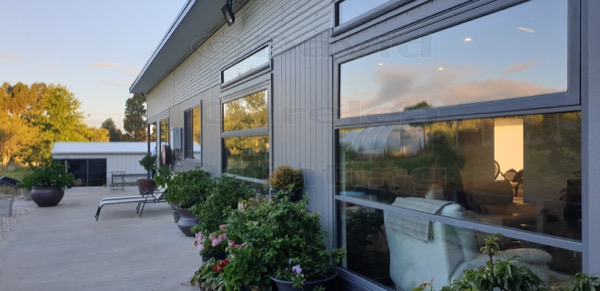 A house exterior and windows in the late afternoon